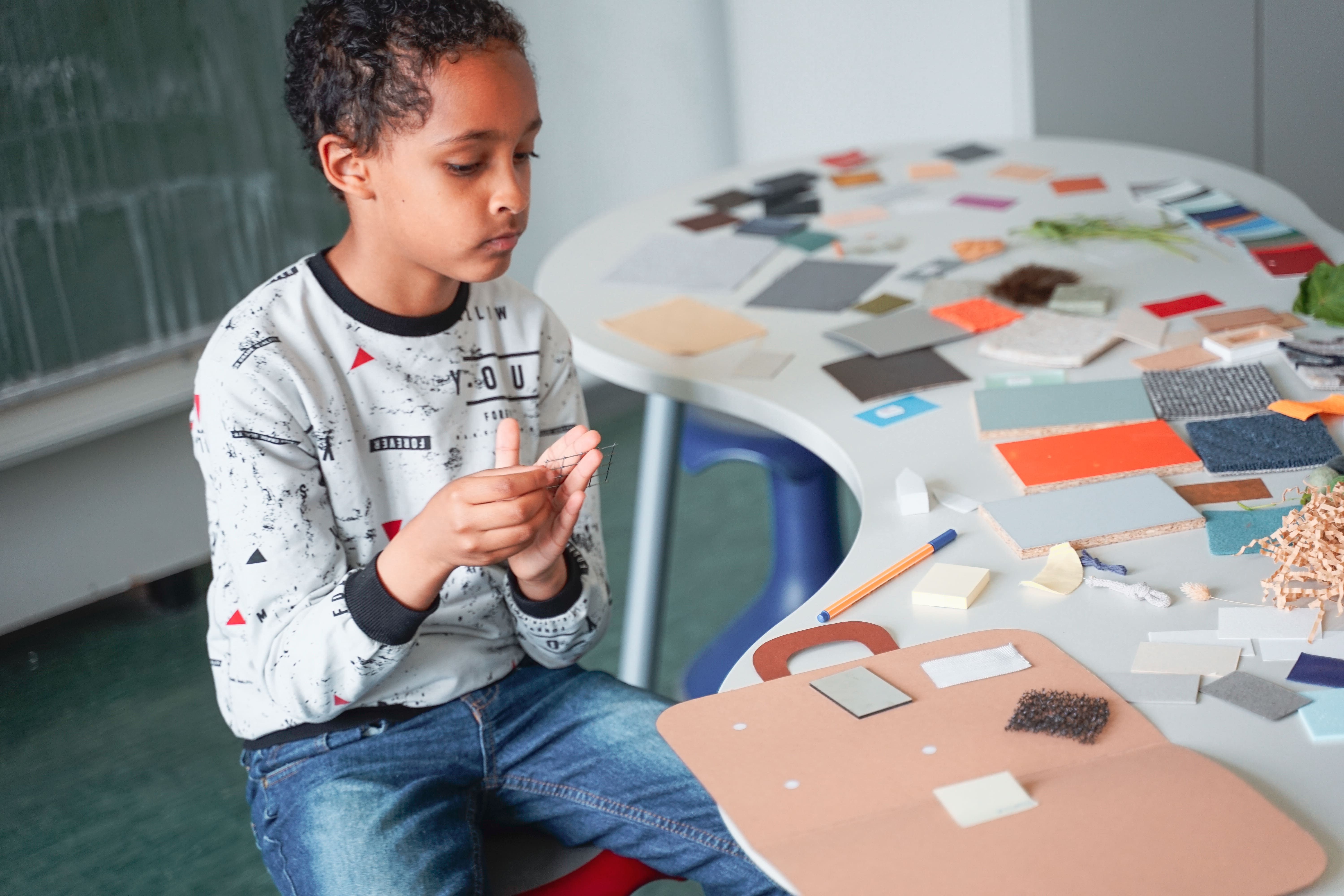Child choosing materials for the suitcase prompt