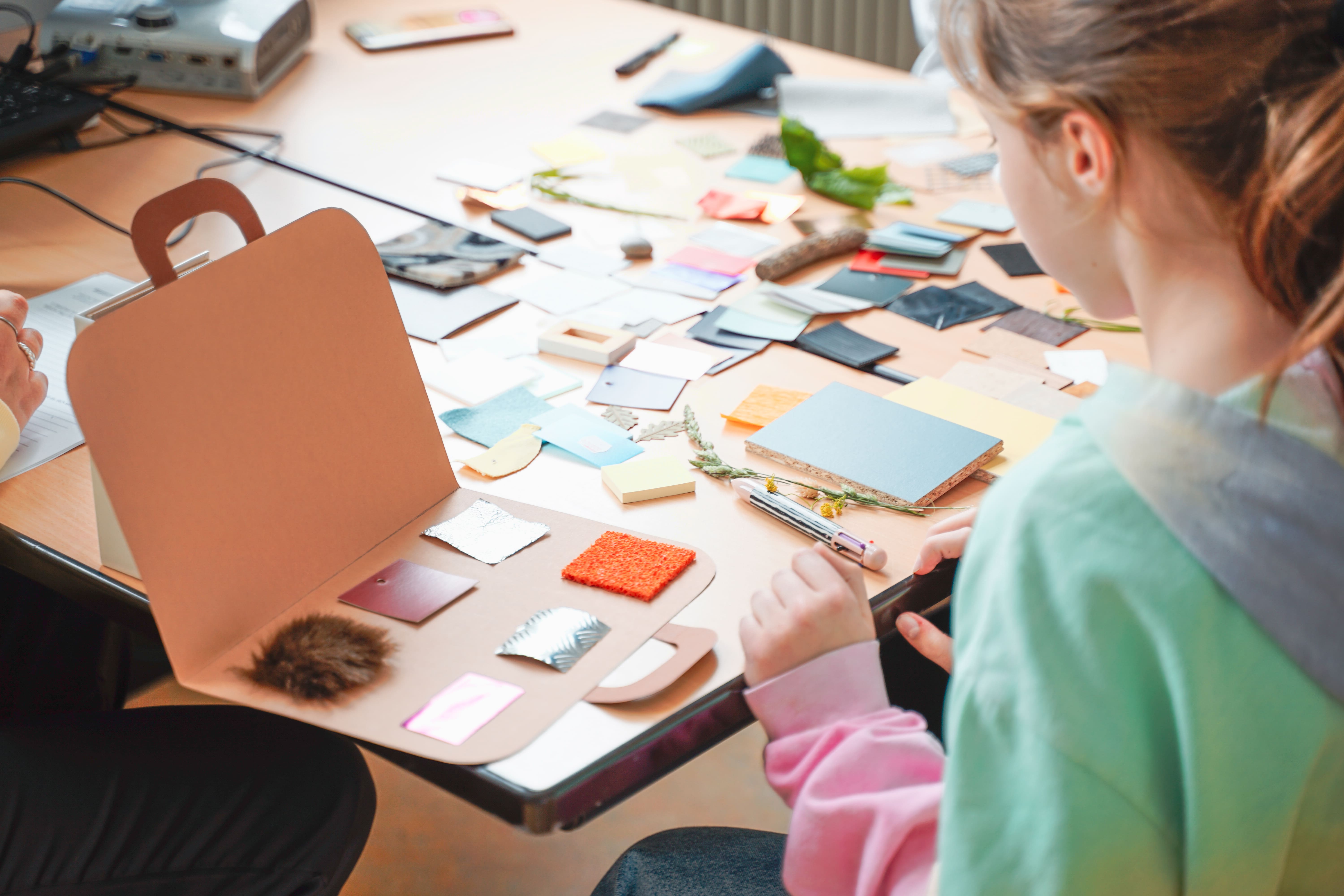 Hands sorting and discussing materials
