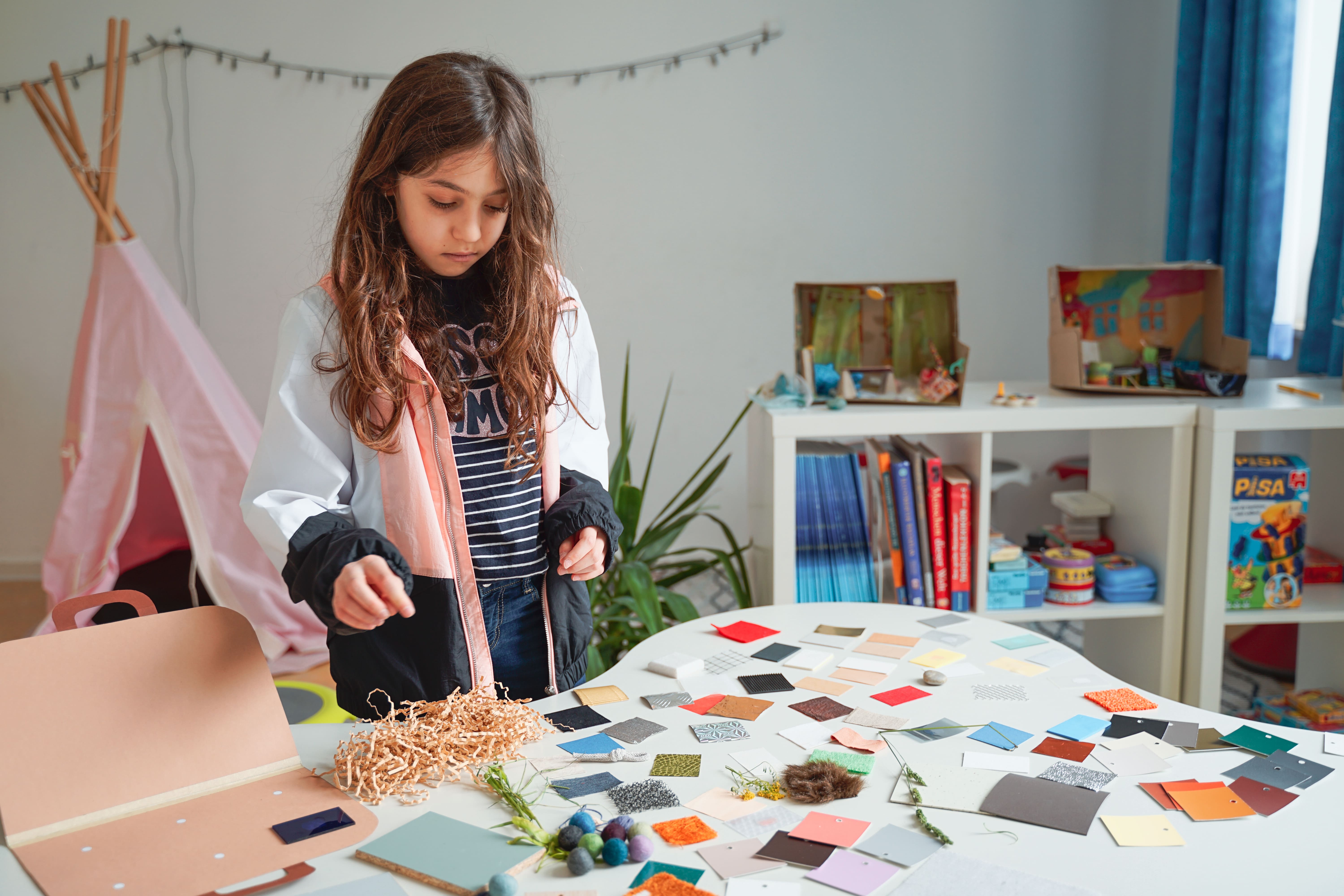 Children working with materials around the table